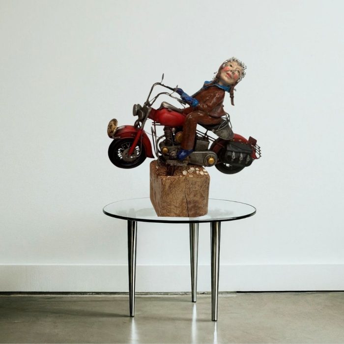 A seated figure poised for adventure in a ceramic sculpture