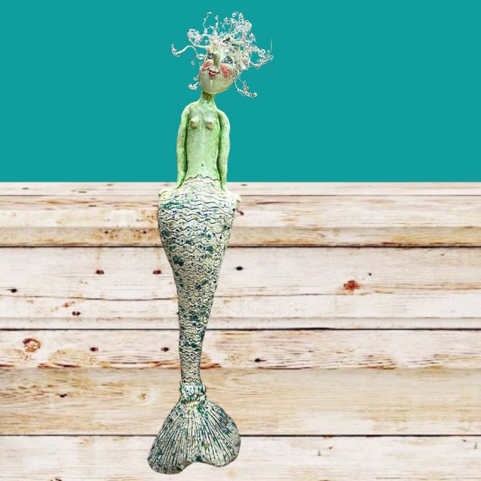 Decorative mermaid sculpture with whimsical wire hair.