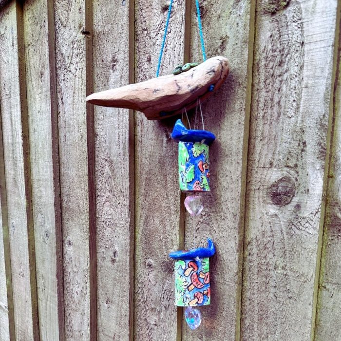 Handcrafted toadstool mobile with detailed embossing and playful design.