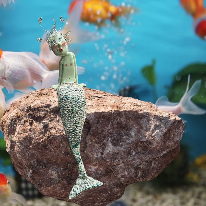 ning merman sculpture with dynamic wire-crafted hair.