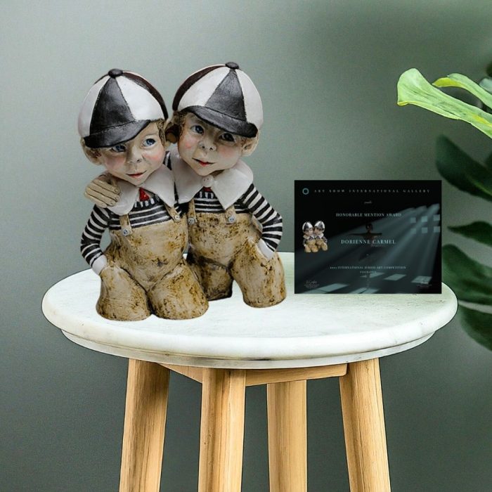 This handcrafted ceramic sculpture features Tweedle Dum and Tweedle Dee dressed in black-and-white striped tops, red ties, beige trousers, and matching school caps, showcasing brotherly love and playful charm.