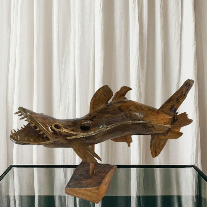 Artisan-crafted wooden fish sculpture with natural details.