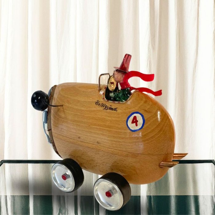 . Artistic wooden car sculpture with smooth cherry wood texture