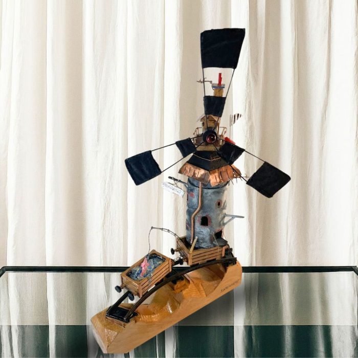 Wooden and mixed media sculpture featuring a journey-inspired theme