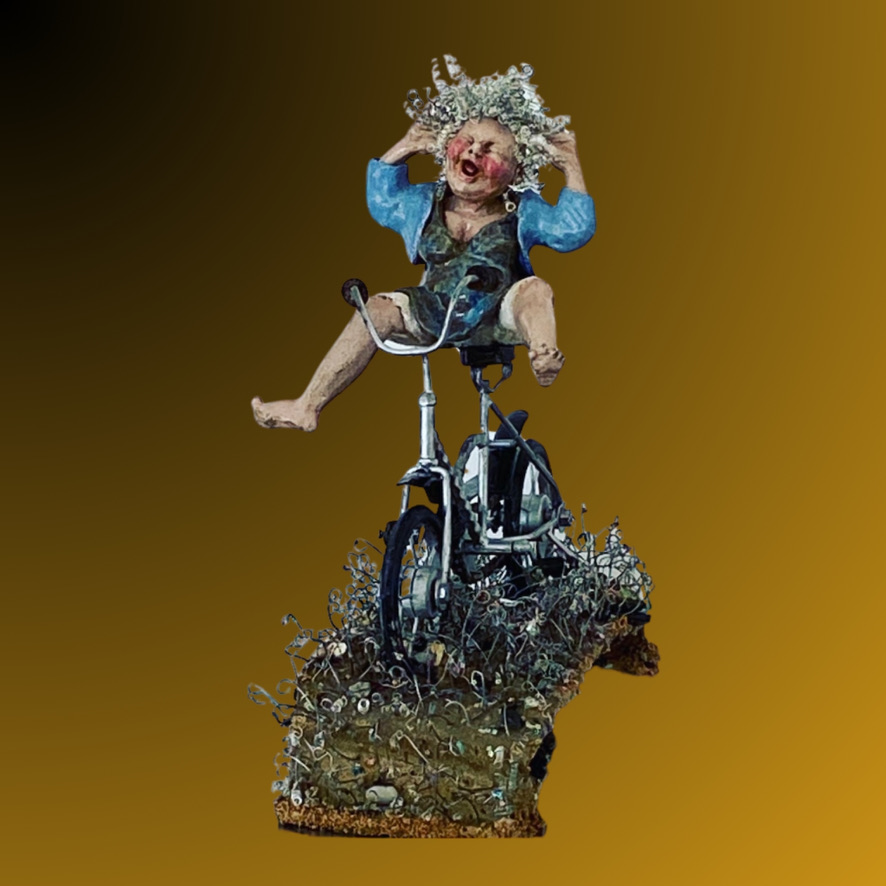 Ceramic figure of a woman with wire curly hair, raising her arms joyfully while cycling, set on a textured grassy ceramic base.